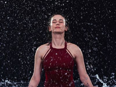 A person captured in a flowing, dynamic yoga transition.