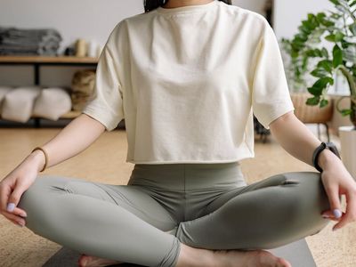 A person sitting with eyes closed in quiet meditation.