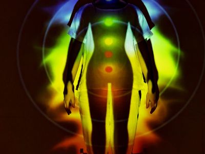 Silhouette of a person in a balancing yoga pose.